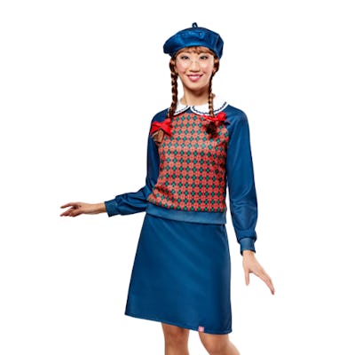 A model poses in a vibrant blue outfit featuring a patterned sweater, a matching skirt, and a blue beret, styled with braided hair and playful expressions.