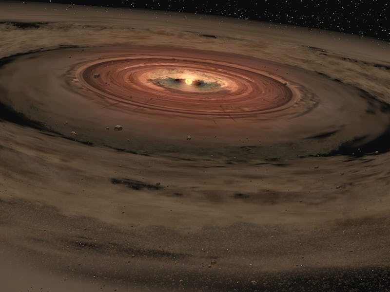 a bright planet surroudned by dusty rings and chunks of rock