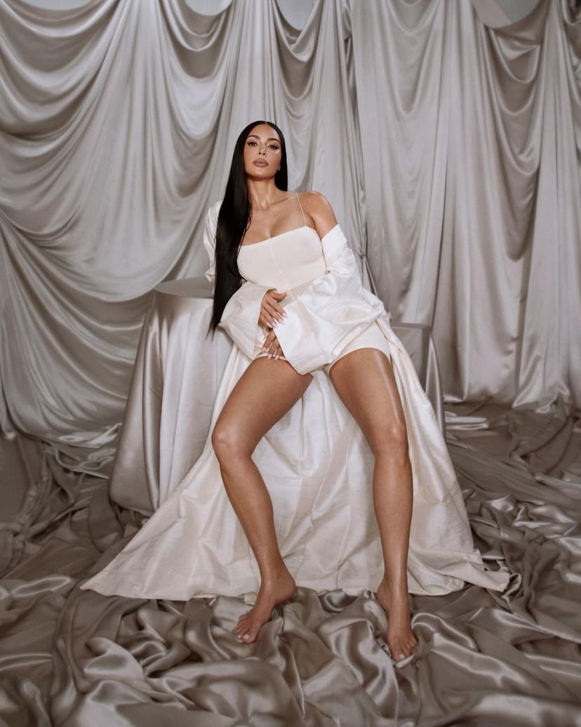 Kim Kardashian wears a white bodysuit and robe in new SKKN BY KIM campaign.