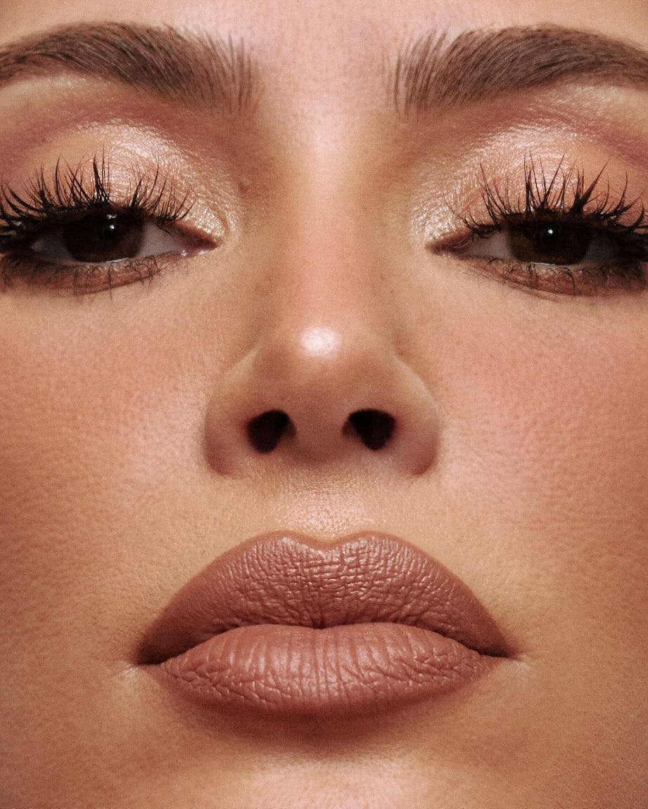 Kim Kardashian wears a white bodysuit and robe in new SKKN BY KIM campaign.