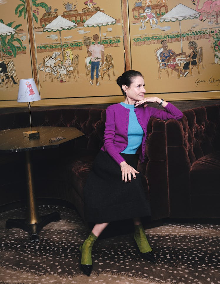 Gabé Doppelt wears a Prada cardigan, sweater, skirt, and shoes; Tiffany & Co. watch; Comme Si socks.