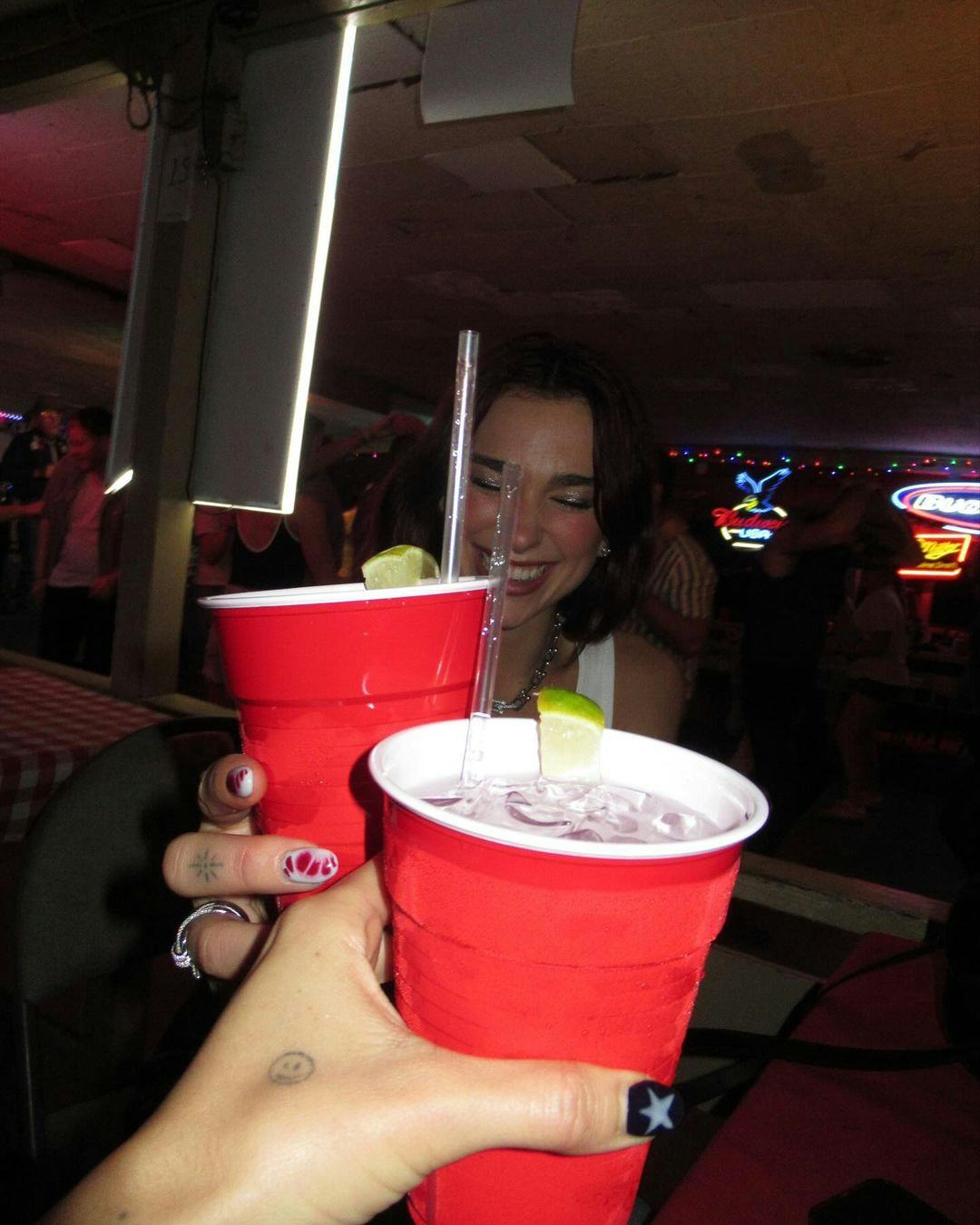 Dua Lipa with a red solo cup. 