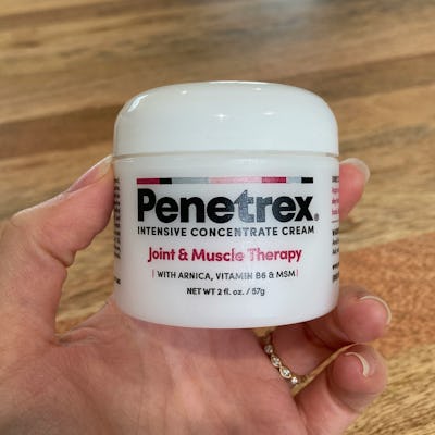Hand holding a jar of Penetrex Intensive Concentrate Cream
