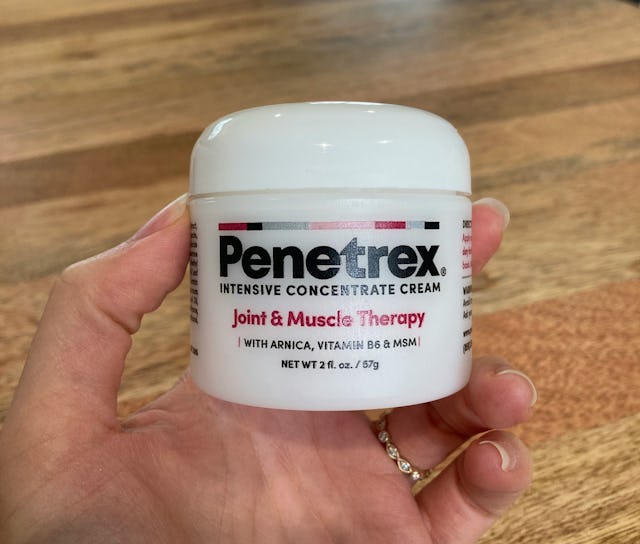 Hand holding a jar of Penetrex Intensive Concentrate Cream