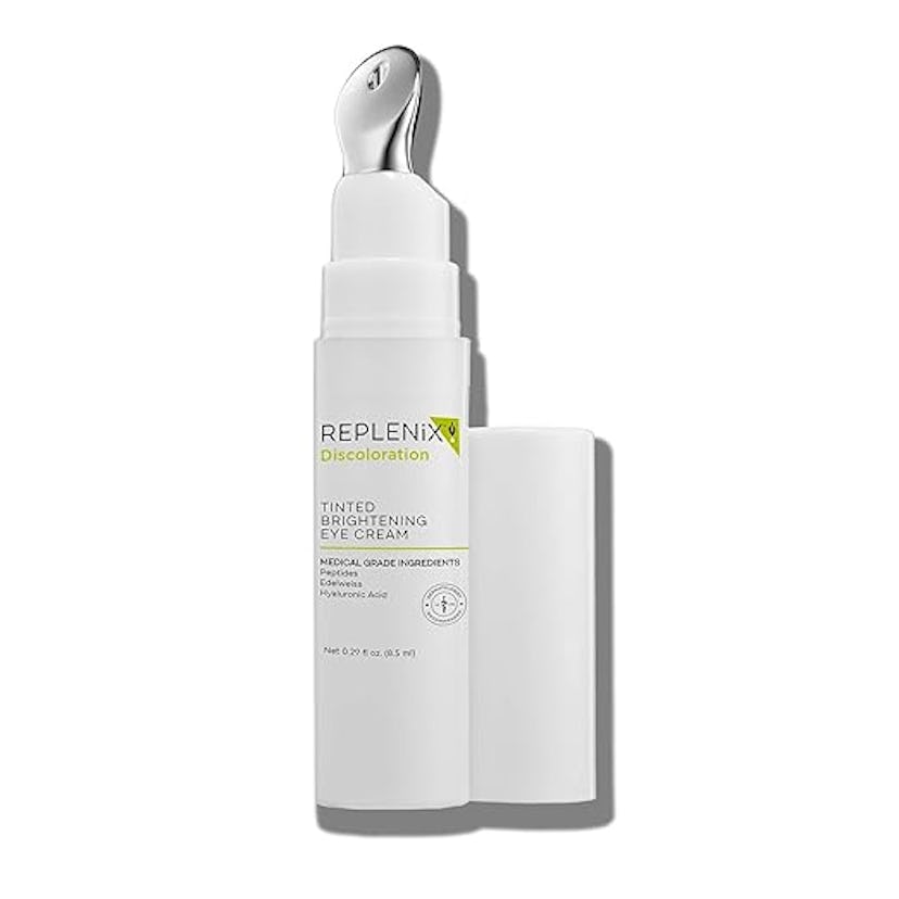 A bottle of Replenix Discoloration Tinted Brightening Eye Cream with a silver applicator tip and whi...