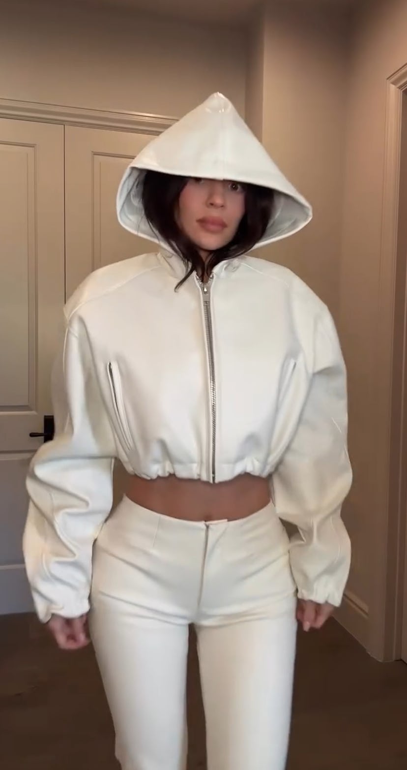 Kylie Jenner wears a white crop jacket.