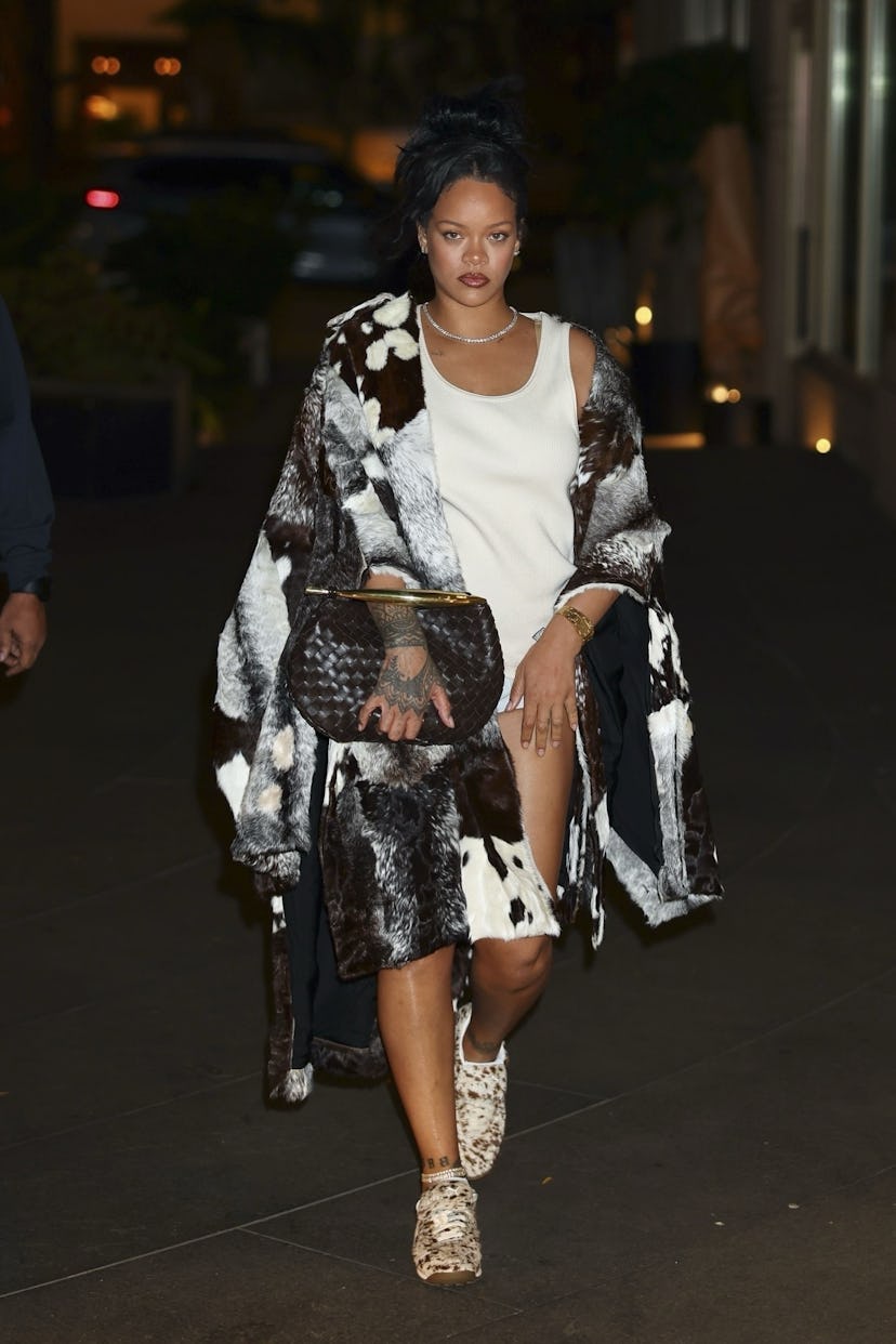 Rihanna wears a white tank and no pants. 