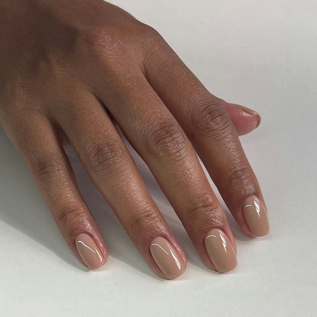 Tonal taupe nail polish is on-trend for fall 2024.