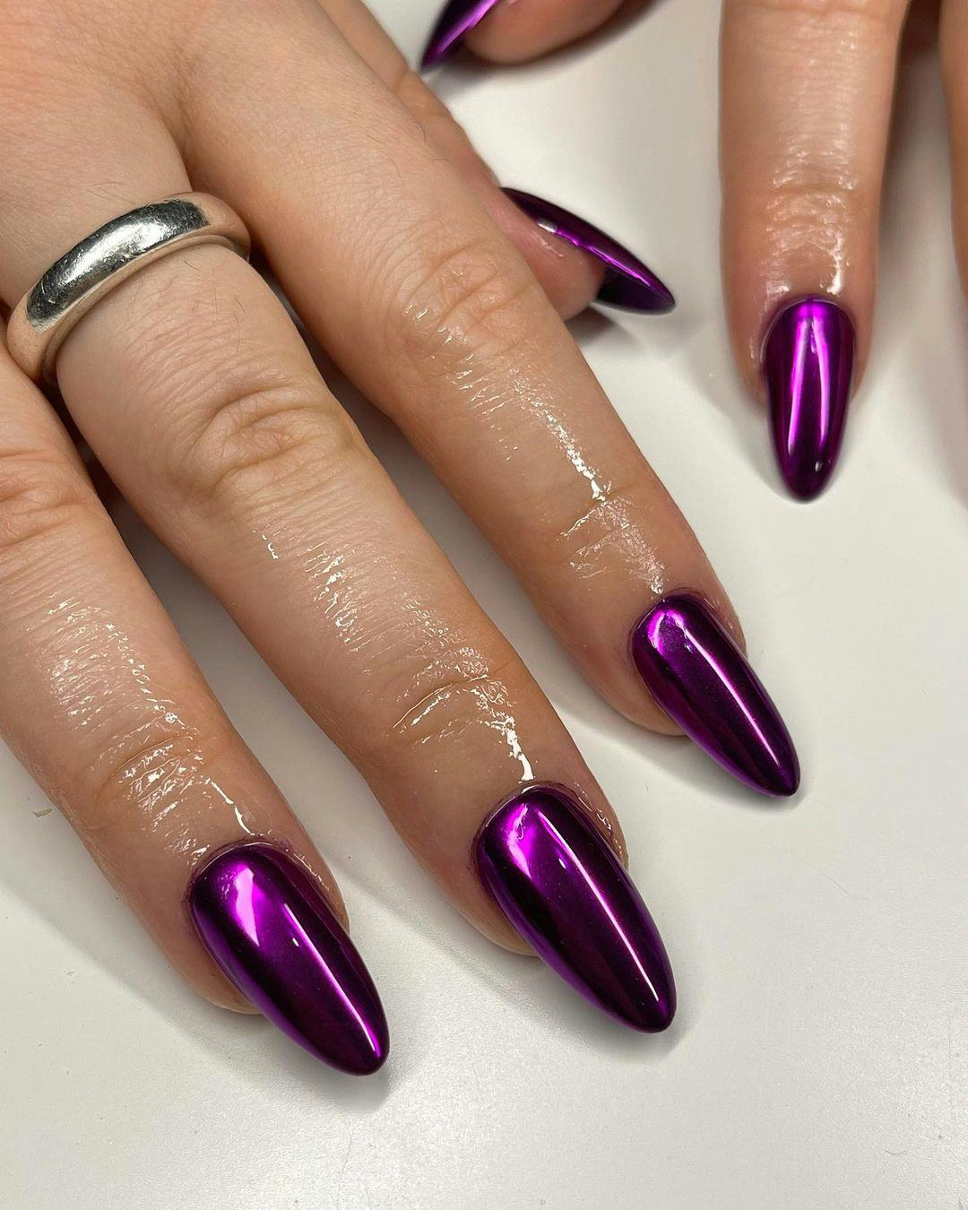 Purple chrome nails are on-trend for fall 2024.