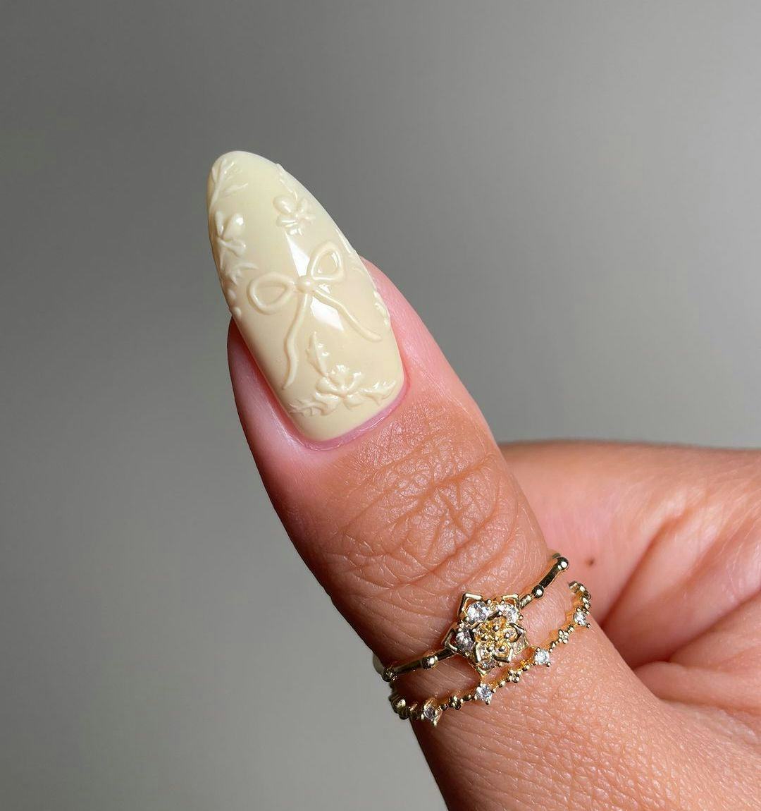 Monochromatic butter yellow 3D ribbon nails match the preppy aesthetic.