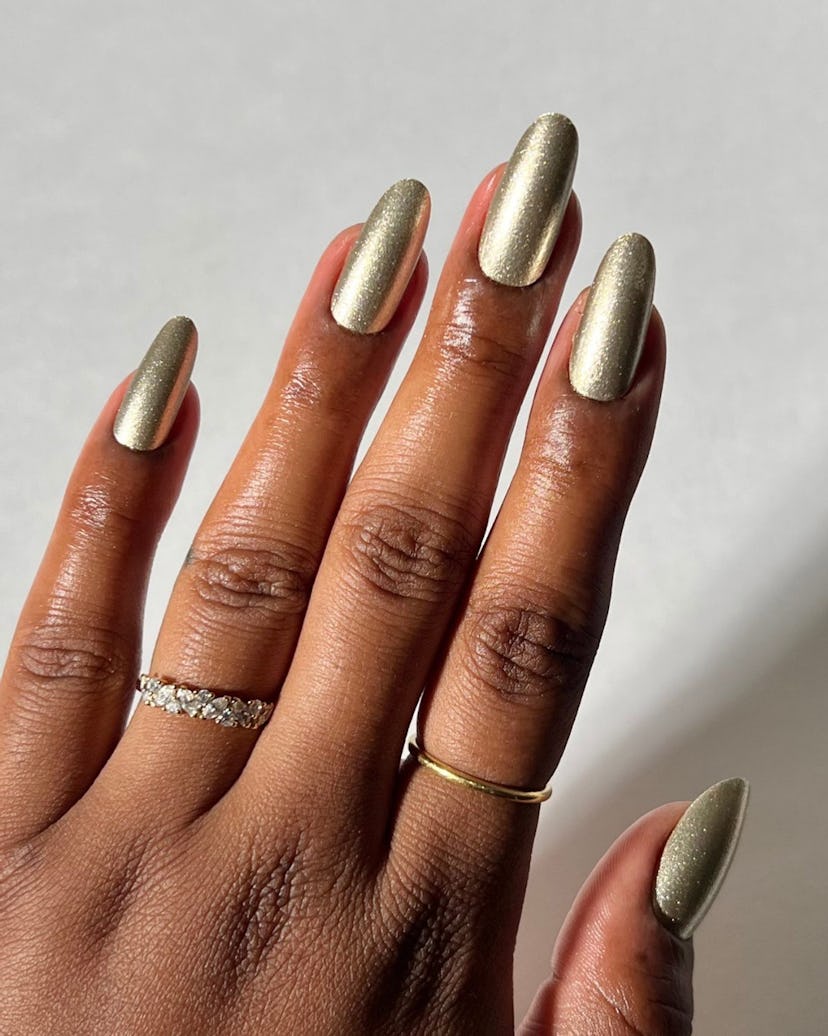 Metallic olive green polish is on-trend for fall 2024.