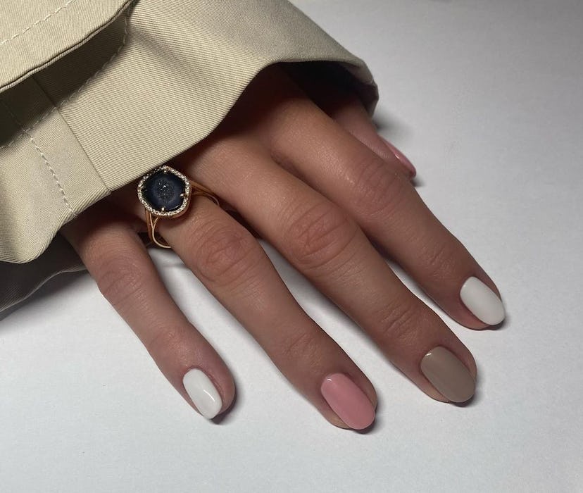 Neutral Skittle nails match the preppy aesthetic.