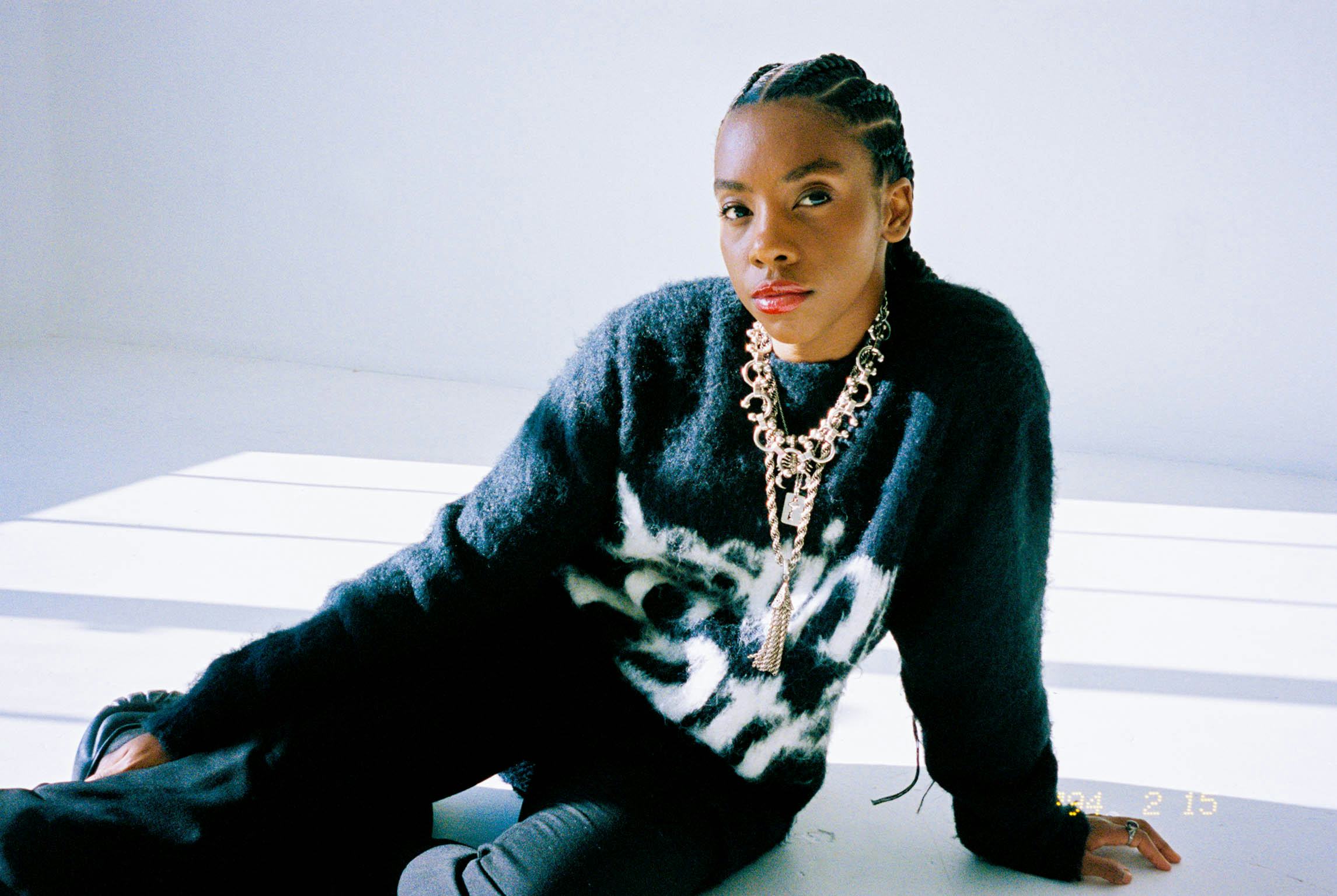 dua saleh sitting in a sunlit white room