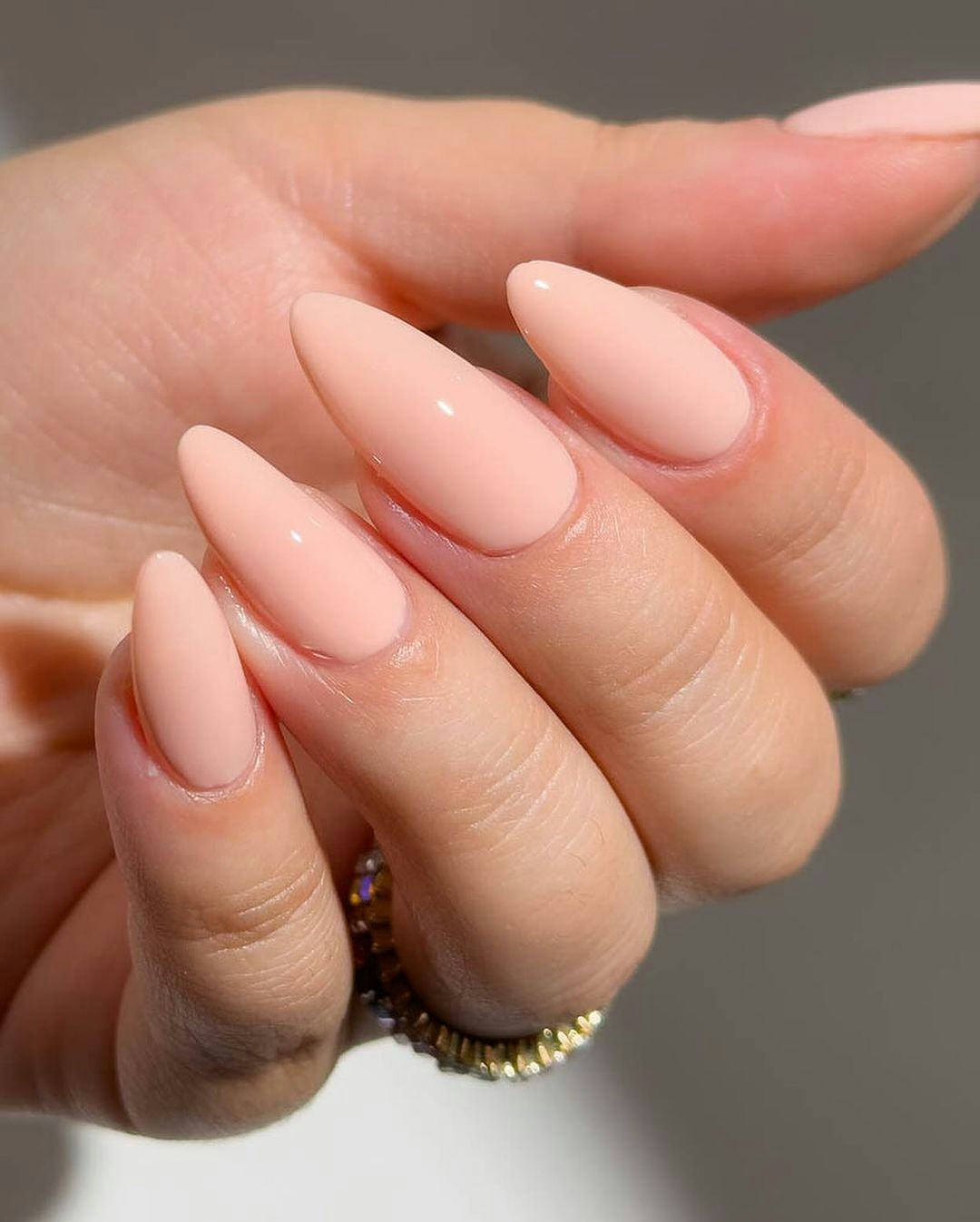 Opaque peach cream nails are on-trend for fall 2024.