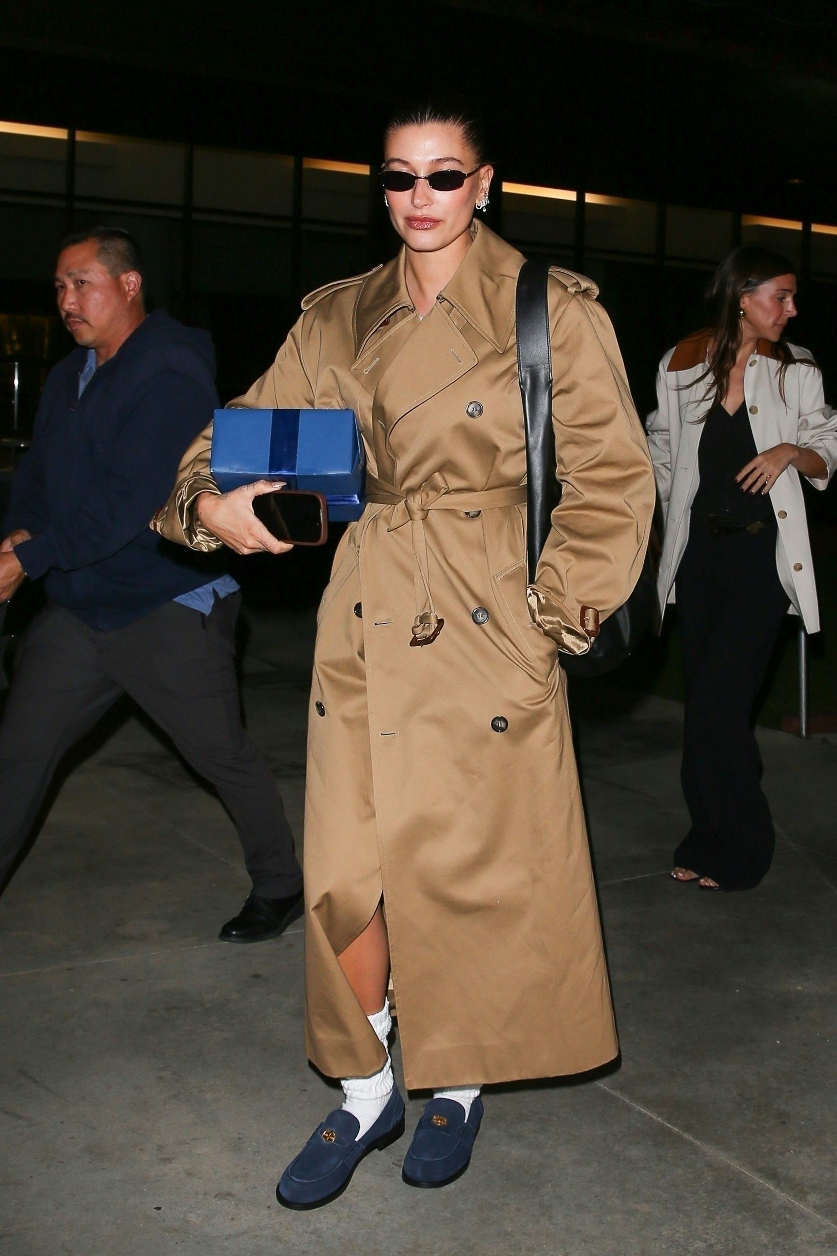 Hailey Bieber wears a trench coat.