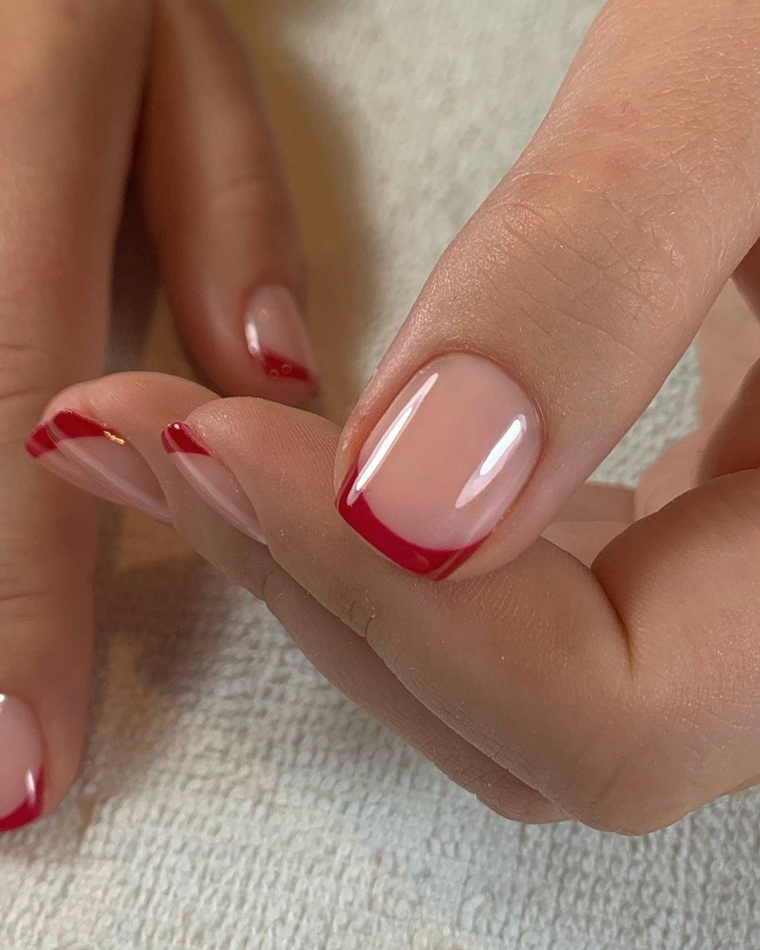 Red French tip nails match the preppy aesthetic.