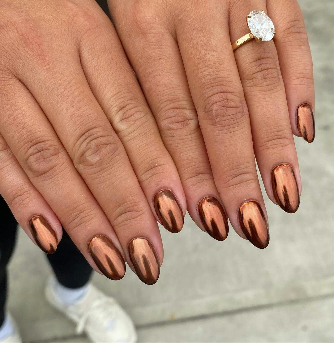 Bronze chrome nails are on-trend for fall 2024.