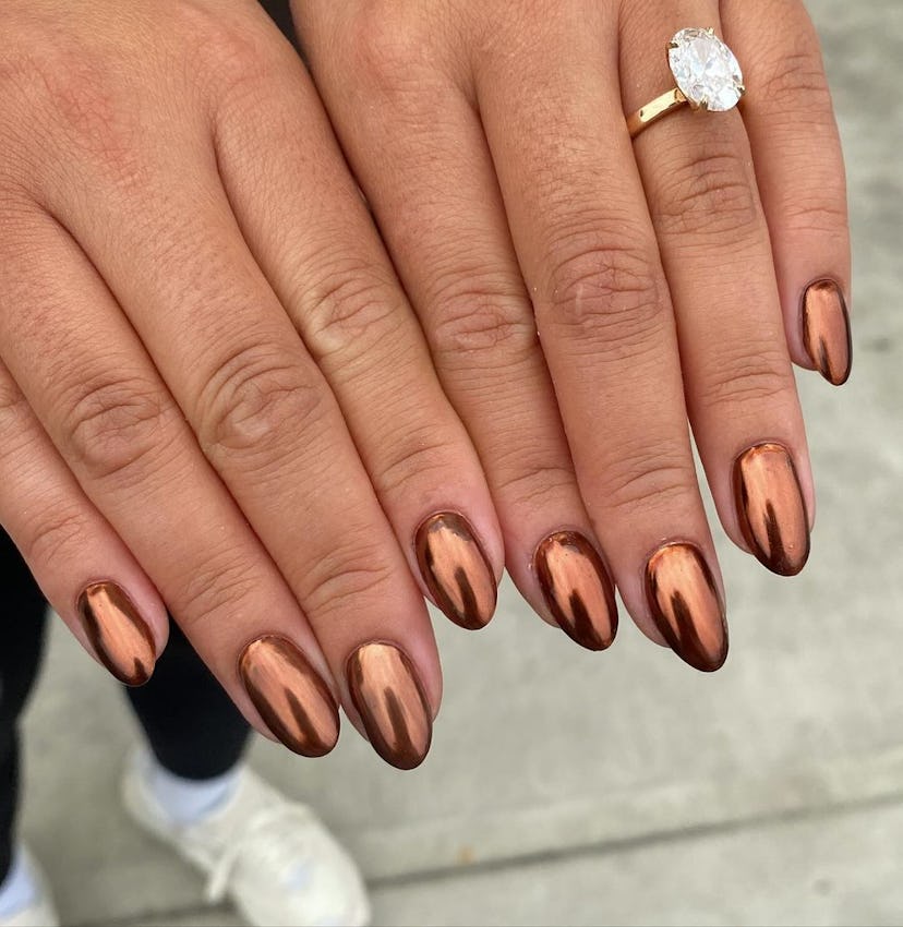 Bronze chrome nails are on-trend for fall 2024.