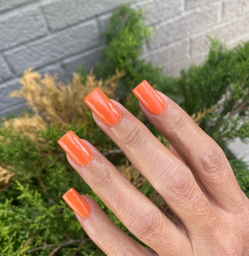 Orange nails are on-trend for fall 2024.