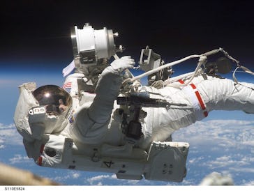 In this April 2002 photo, astronaut Jerry L. Ross, STS-110 mission specialist, is anchored to the mo...
