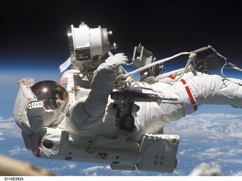 In this April 2002 photo, astronaut Jerry L. Ross, STS-110 mission specialist, is anchored to the mo...