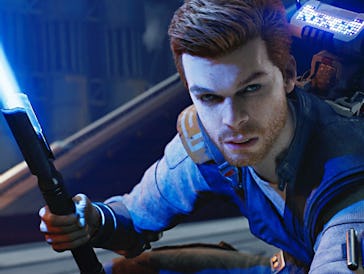 A young man with short brown hair holds a blue lightsaber in a dynamic pose. He wears a futuristic o...