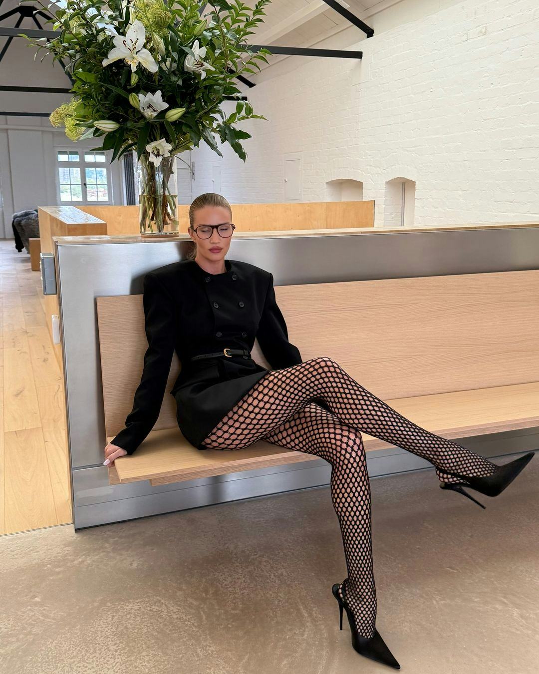 Rosie Huntington-Whiteley wears a blazer dress with fishnet tights.