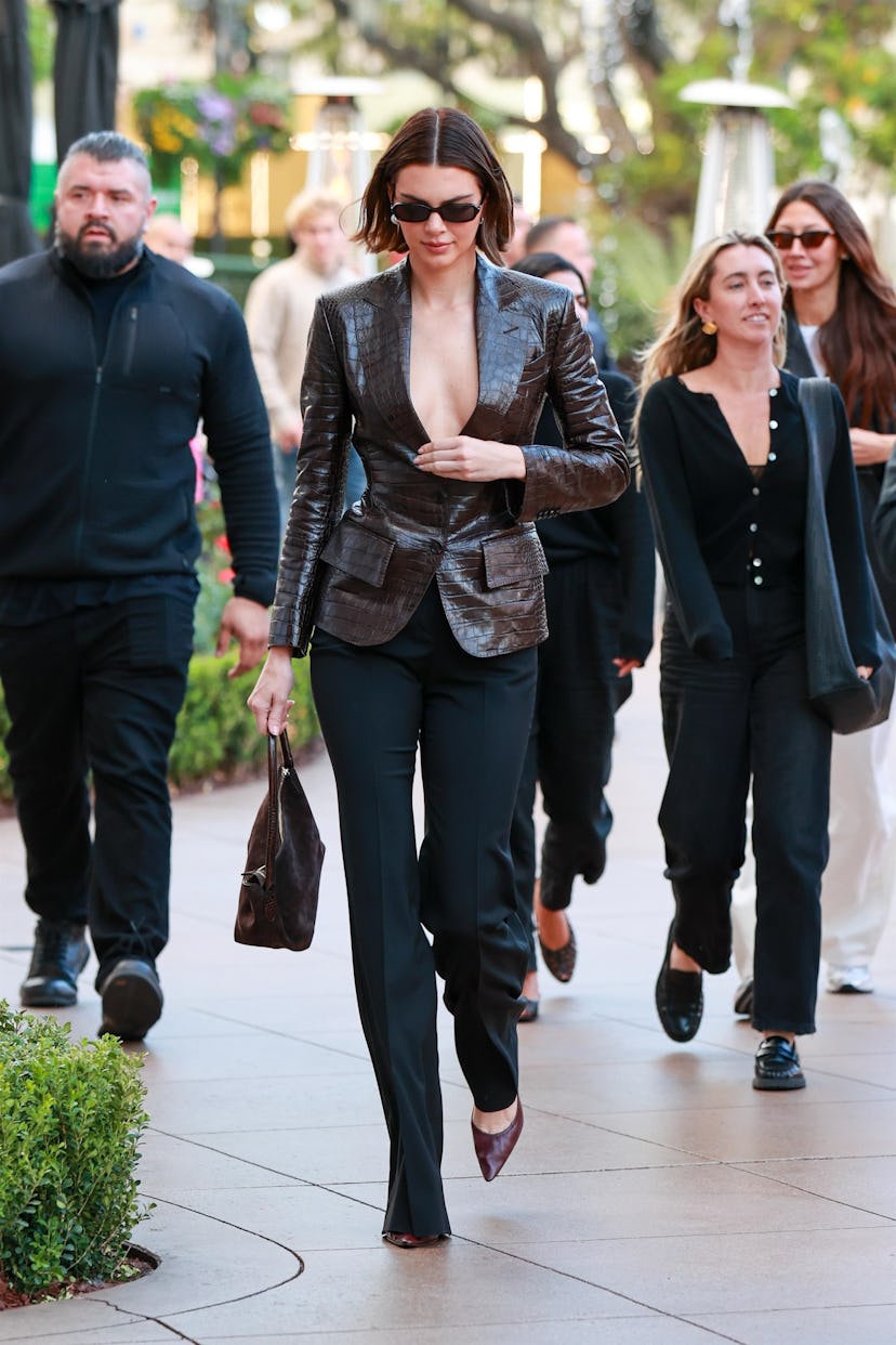 Kendall Jenner wears a plunging blazer with trousers.