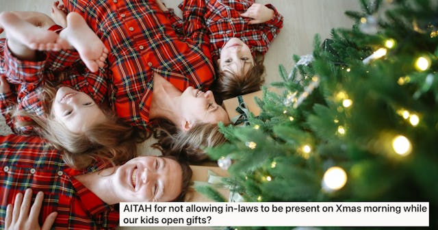 A family in matching red plaid pajamas lies on the floor, smiling, surrounded by Christmas decoratio...