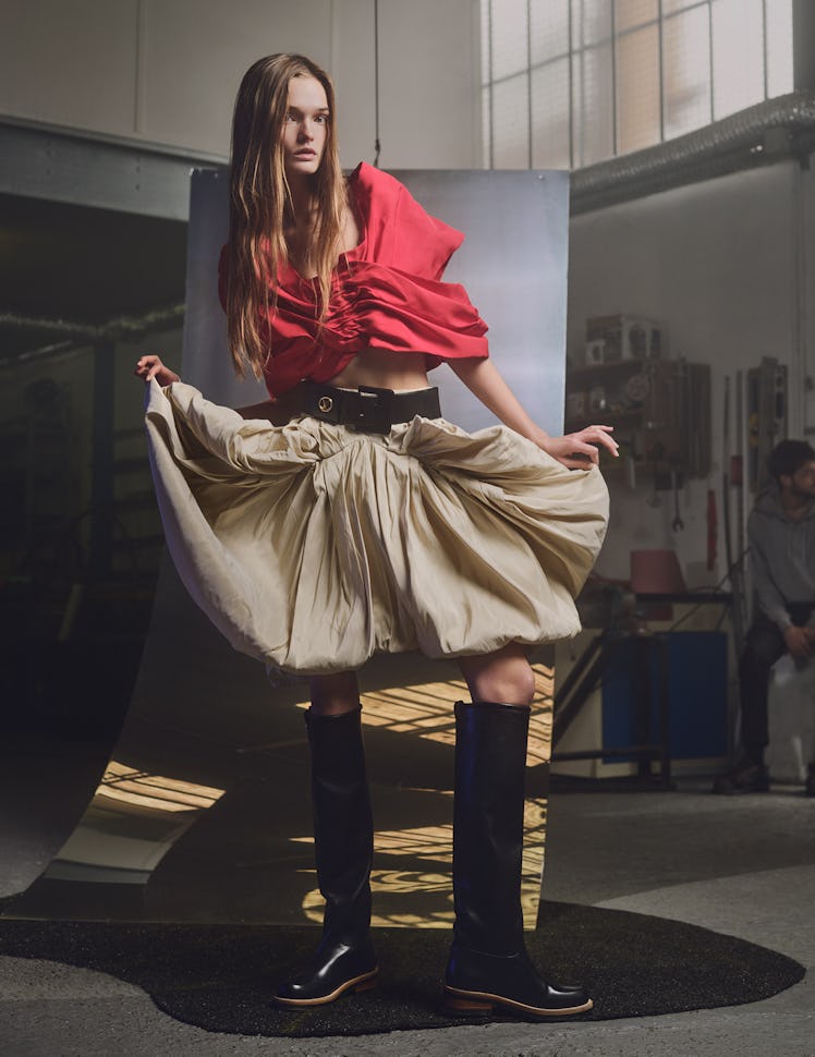 In Mohamed Bourouissa’s studio, Lulu Tenney wears a Louis Vuitton top, skirt, belt, and boots.