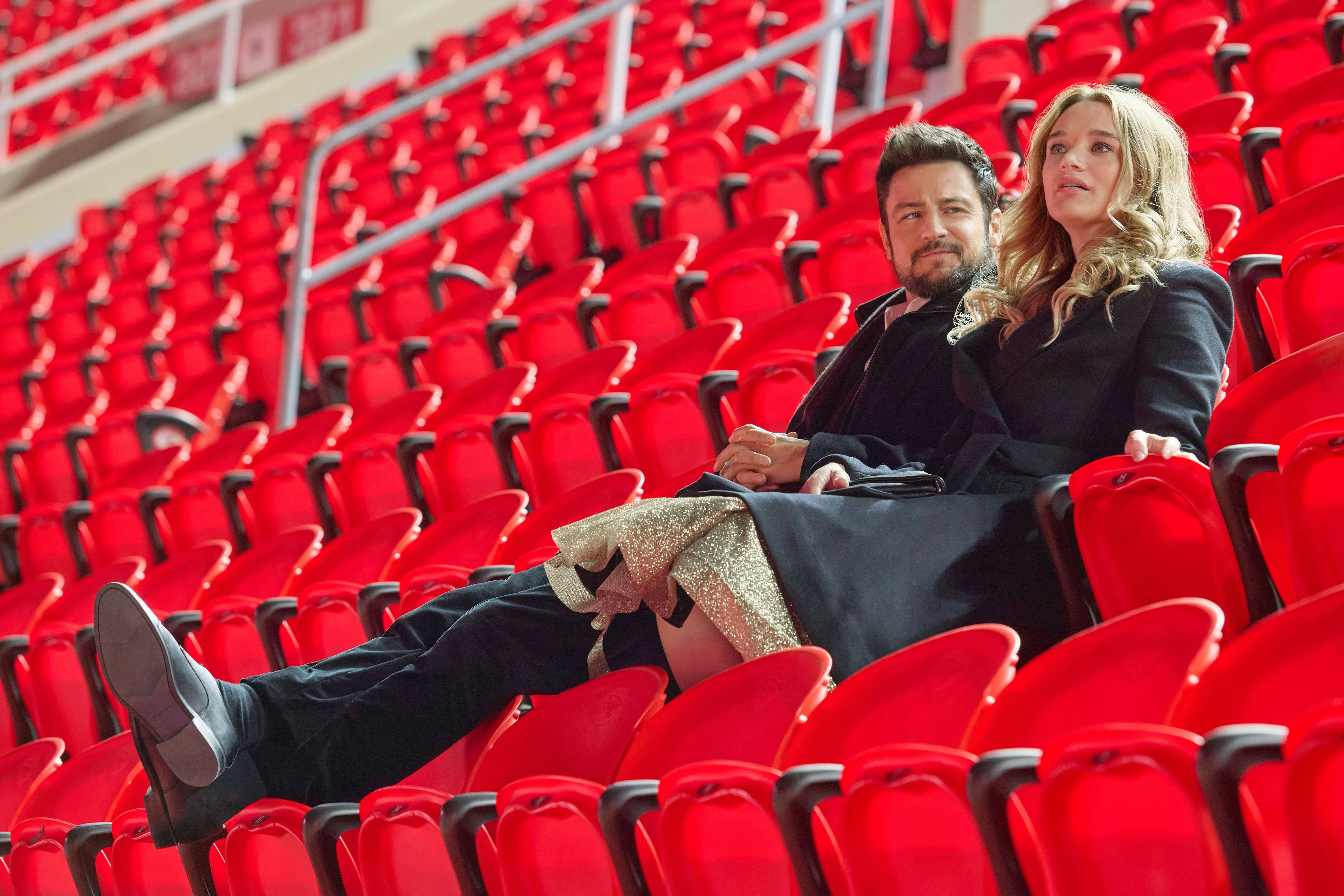 Tyler Hynes and Hunter King in Holiday Touchdown. Photo via Hallmark Media