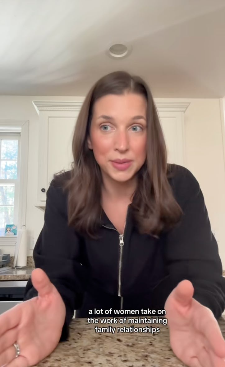 A woman with shoulder-length brown hair speaks animatedly at a kitchen counter, discussing women's r...