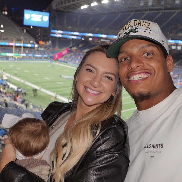 Allie Kuch and Isaac Rochell with their daughter Scottie Bee at a football game.