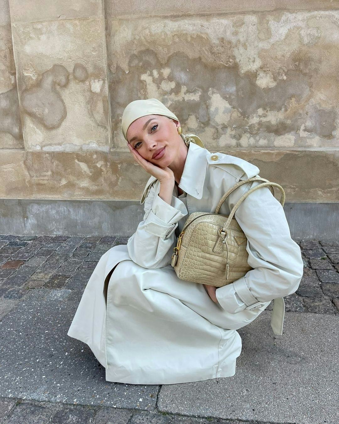 Elsa Hosk wears an ivory trench coat.