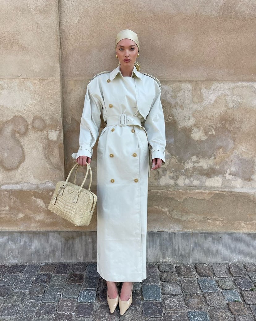 Elsa Hosk wears an ivory trench coat.