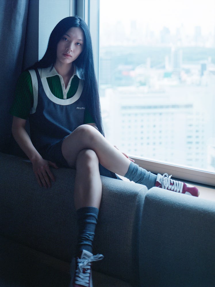 Raiki Yamamoto wears a Miu Miu dress, top, socks, and sneakers.
