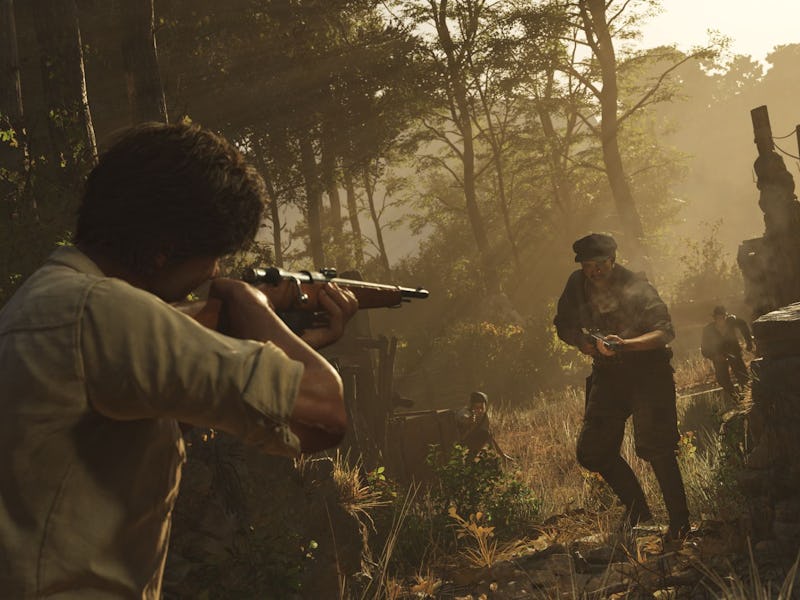 Enzo fires a rifle in the woods