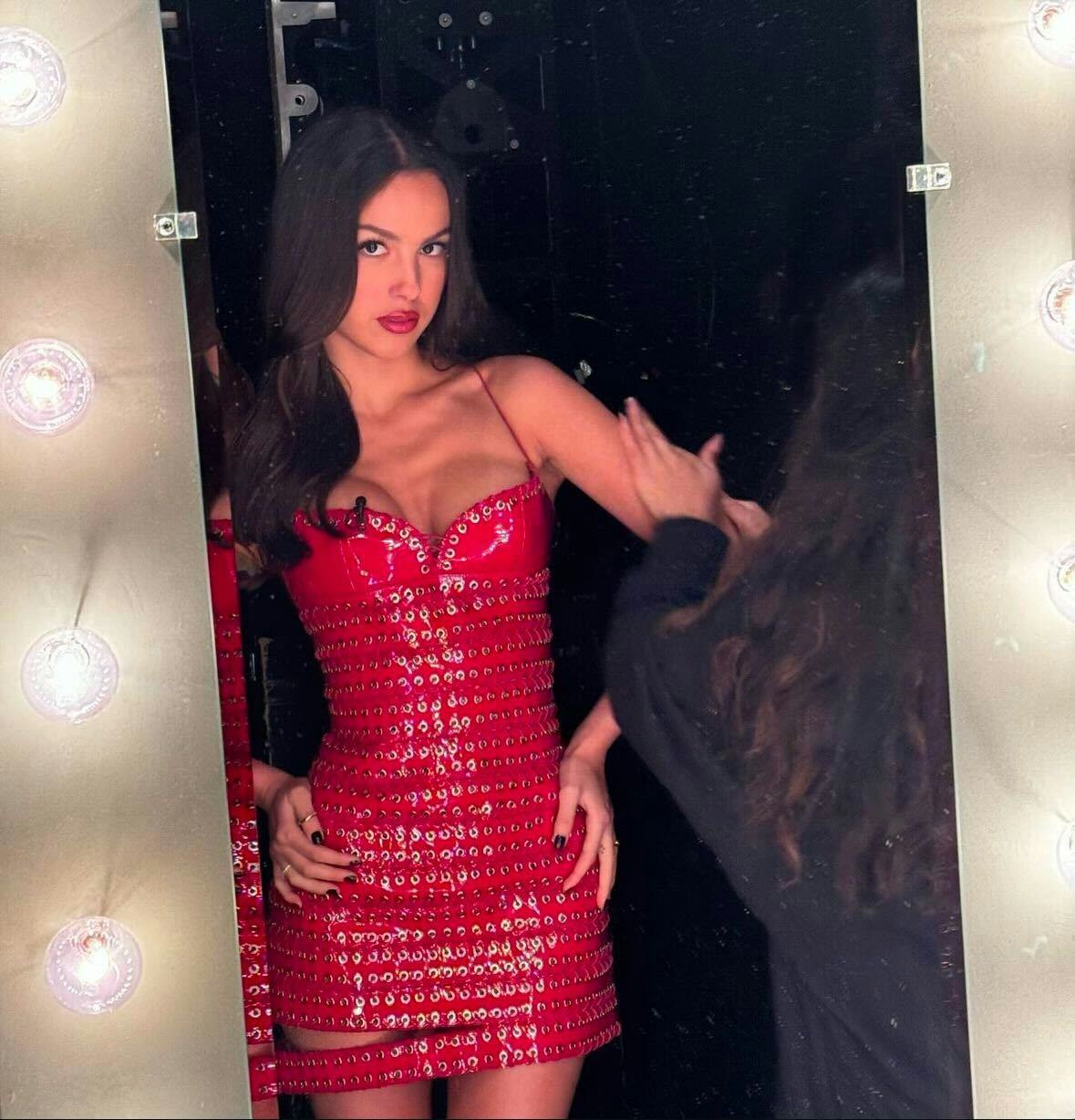 Olivia Rodrigo wearing a red chain dress for Tonight Show appearance in 2024.
