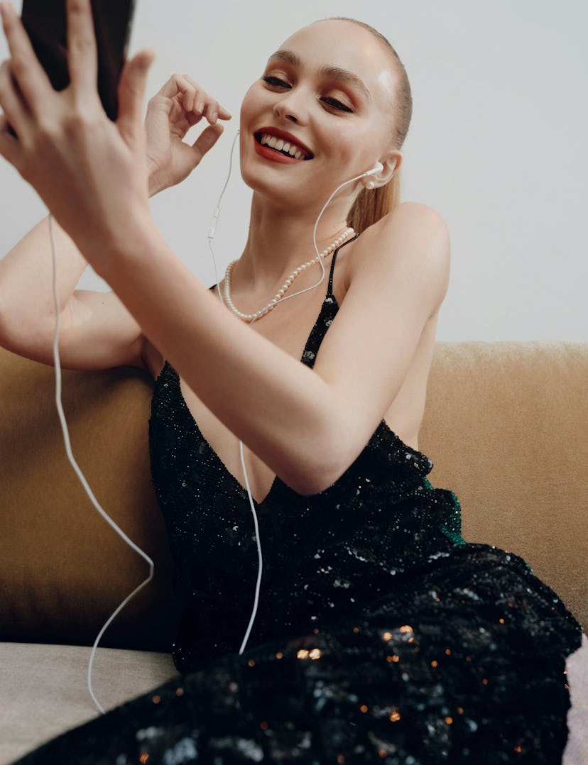 Lily Rose Depp wearing earbuds