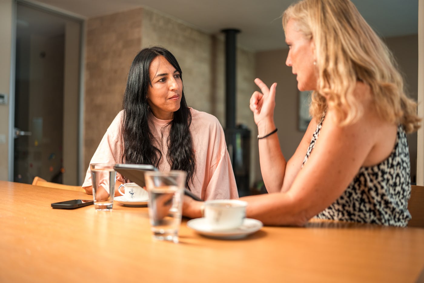 Two women have an intense conversation.