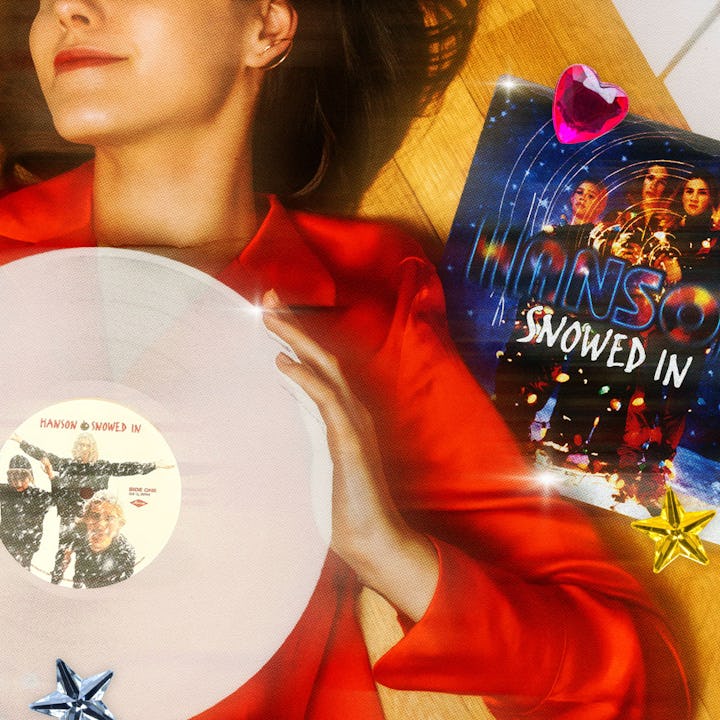 A woman holds Hanson's 'Snowed In' Christmas album.