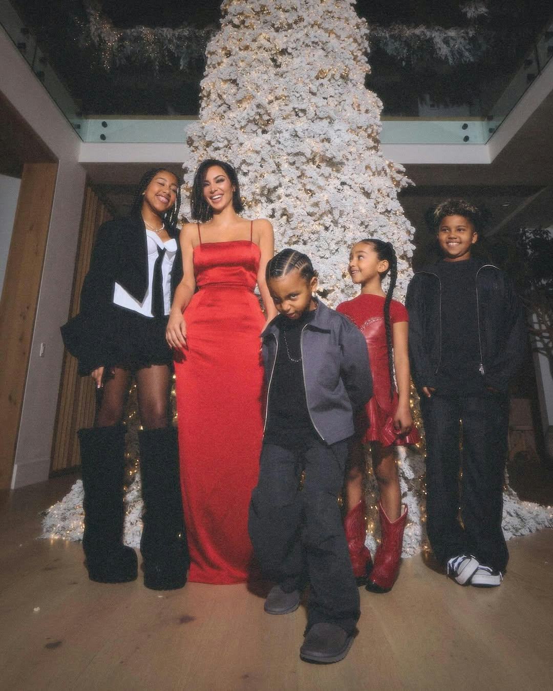 Kim Kardashian poses with her kids North, Chicago, Saint, and Psalm.