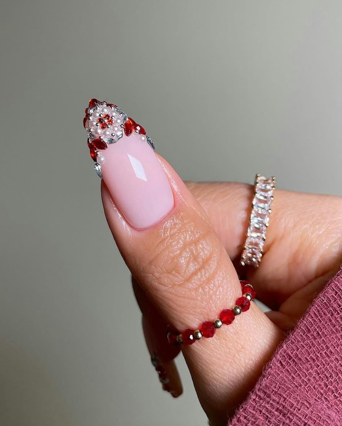 Try red and white rhinestone-studded French tip nails for Christmas 2024.