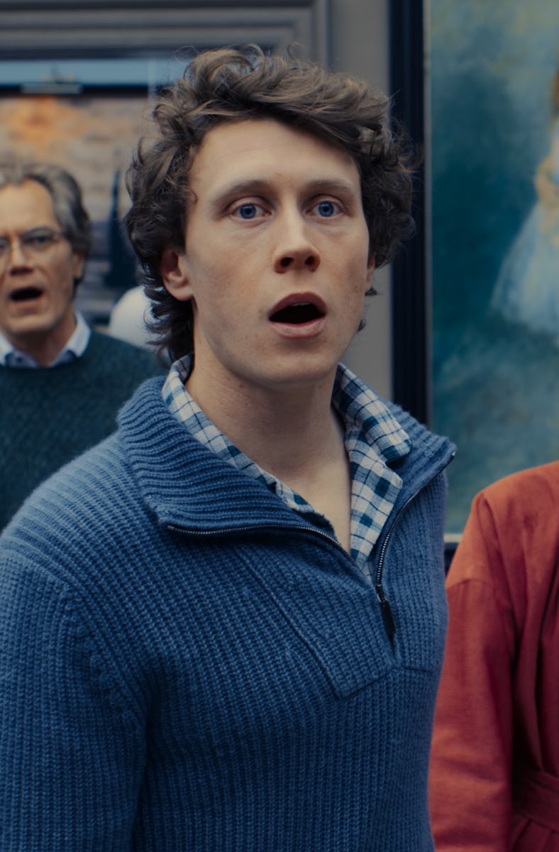 A group of six individuals stands in an art-filled room, expressing surprise while singing. The scen...
