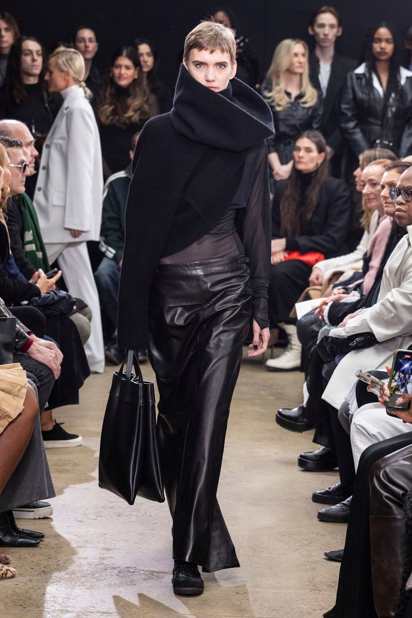 Proenza Schouler model in black asymmetrical funnel neck top and maxi leather skirt