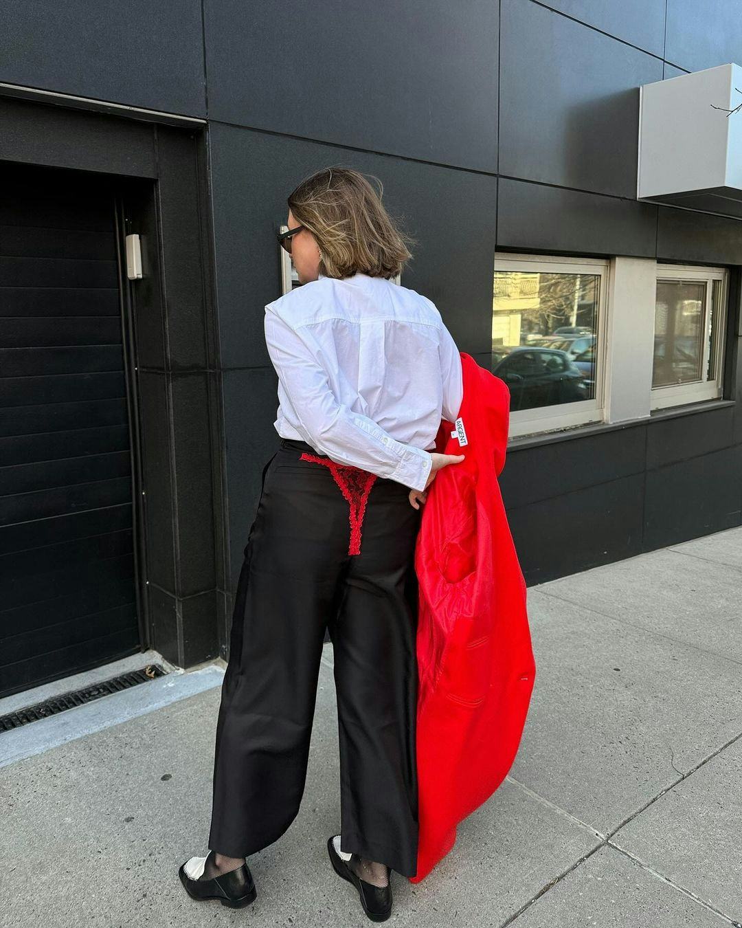 kelsey stiegman attends new york fashion week february 2024 in red lace thong pants