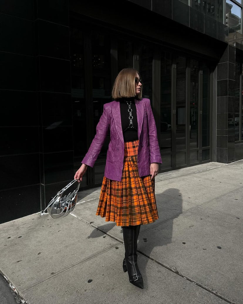 kelsey stiegman at new york fashion week in a plaid skirt and leather blazer