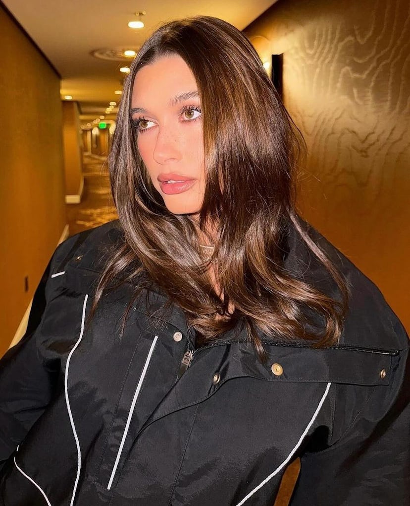 Hailey Bieber wears a black jacket bodysuit.