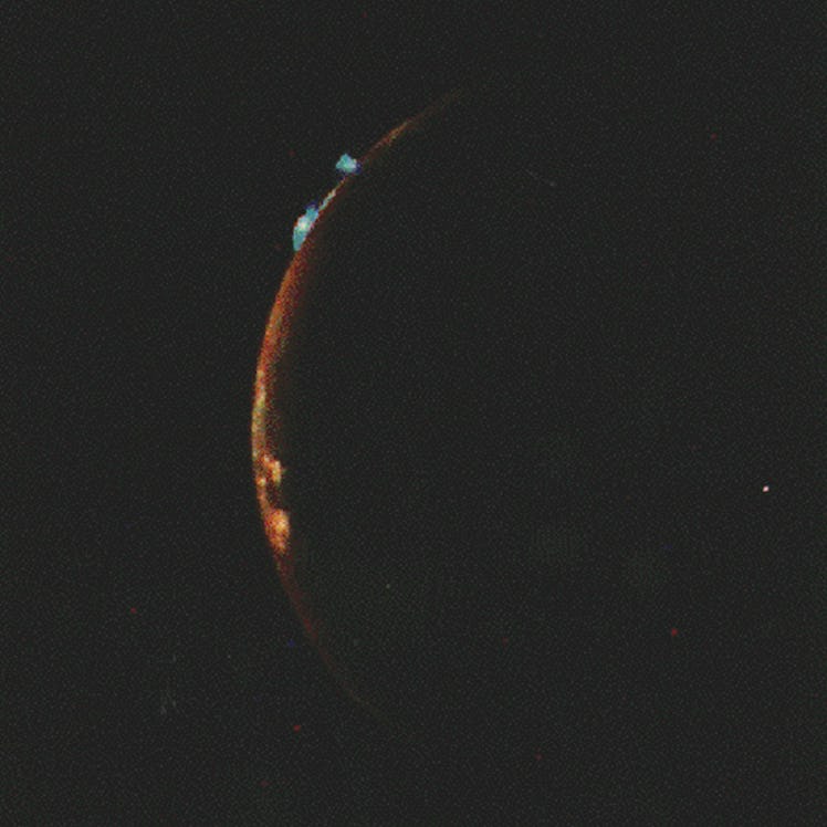 image of the edge of a planet in orange, with blue volcanic plumes, on a black background