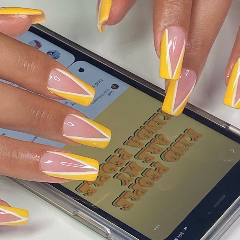 Double-lined yellow "tuxedo" nails are on-trend.